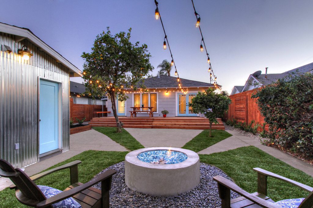 Country backyard patio photo in Los Angeles with a fire pit and no cover