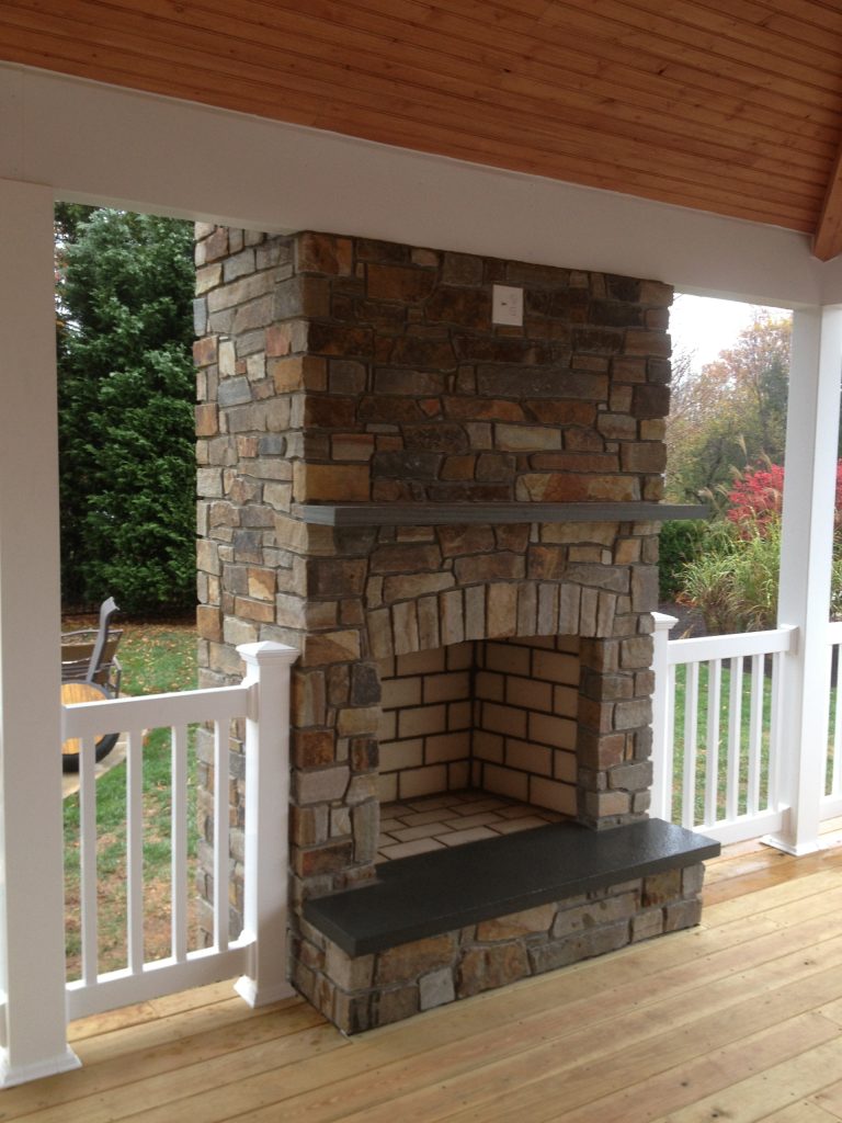 thin veneer natural stone on outside fireplace with covered porch,