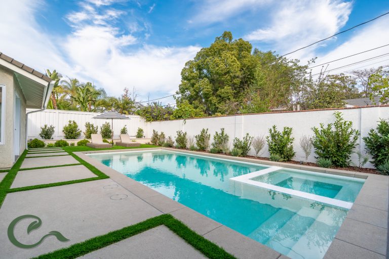 A simple, but elegant pool creates a relaxing environment. Concrete pads w/ turf accent the perimeter of the pool.