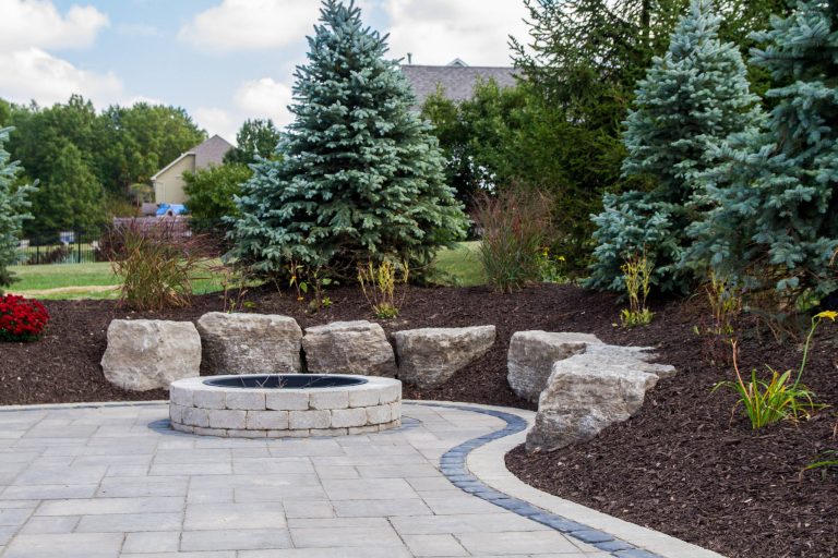Patio - mid-sized traditional backyard stone patio idea in Chicago with a fire pit and no cover
