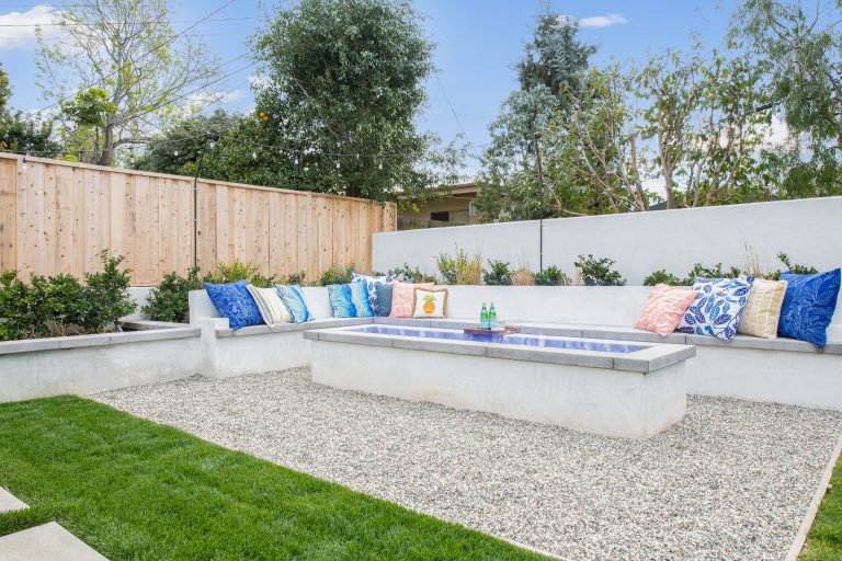 Patio - transitional backyard gravel patio idea in Orange County with a fire pit and no cover