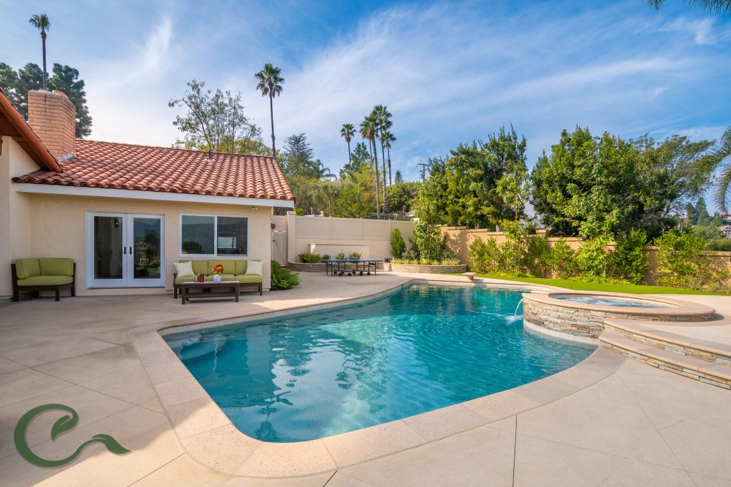 This pool was remodeled to include a new raised spa w/ water feature, elegant pool tile, precast coping by Pacific Stone, and Pebble Tec finish.