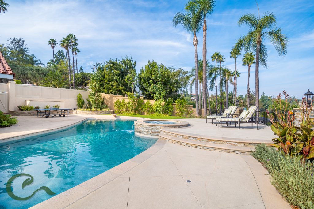 This pool was remodeled to include a new raised spa w/ water feature, elegant pool tile, precast coping by Pacific Stone, and Pebble Tec finish.