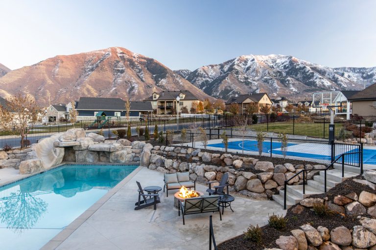 Huge transitional front yard concrete patio photo in Salt Lake City with a fire pit and no cover