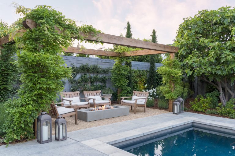 Patio - mid-sized french country gravel patio idea in San Francisco with a fire pit and a pergola