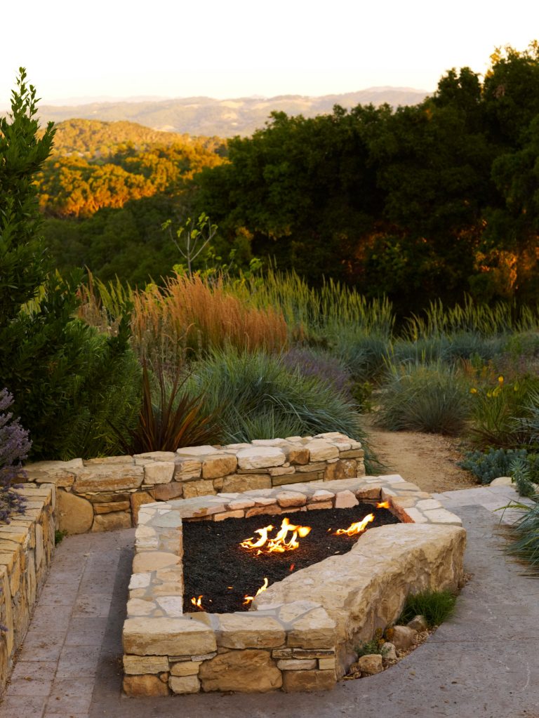 Large trendy backyard stone patio photo in San Luis Obispo with a fire pit