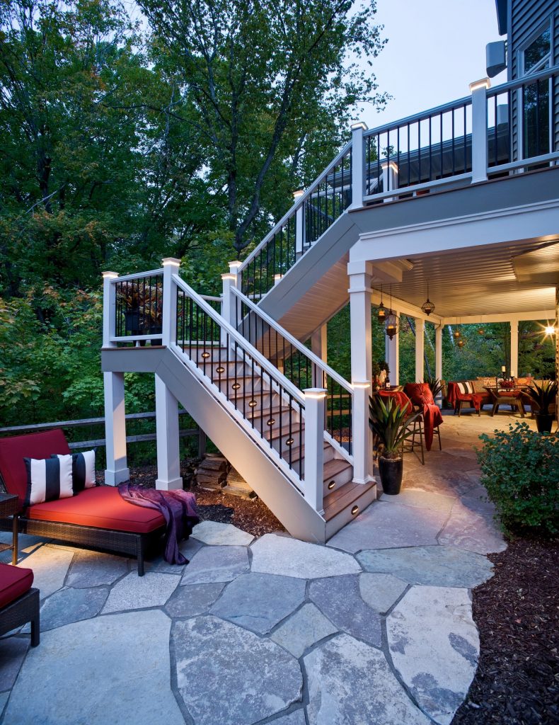 Deck steps leading to stone patio.