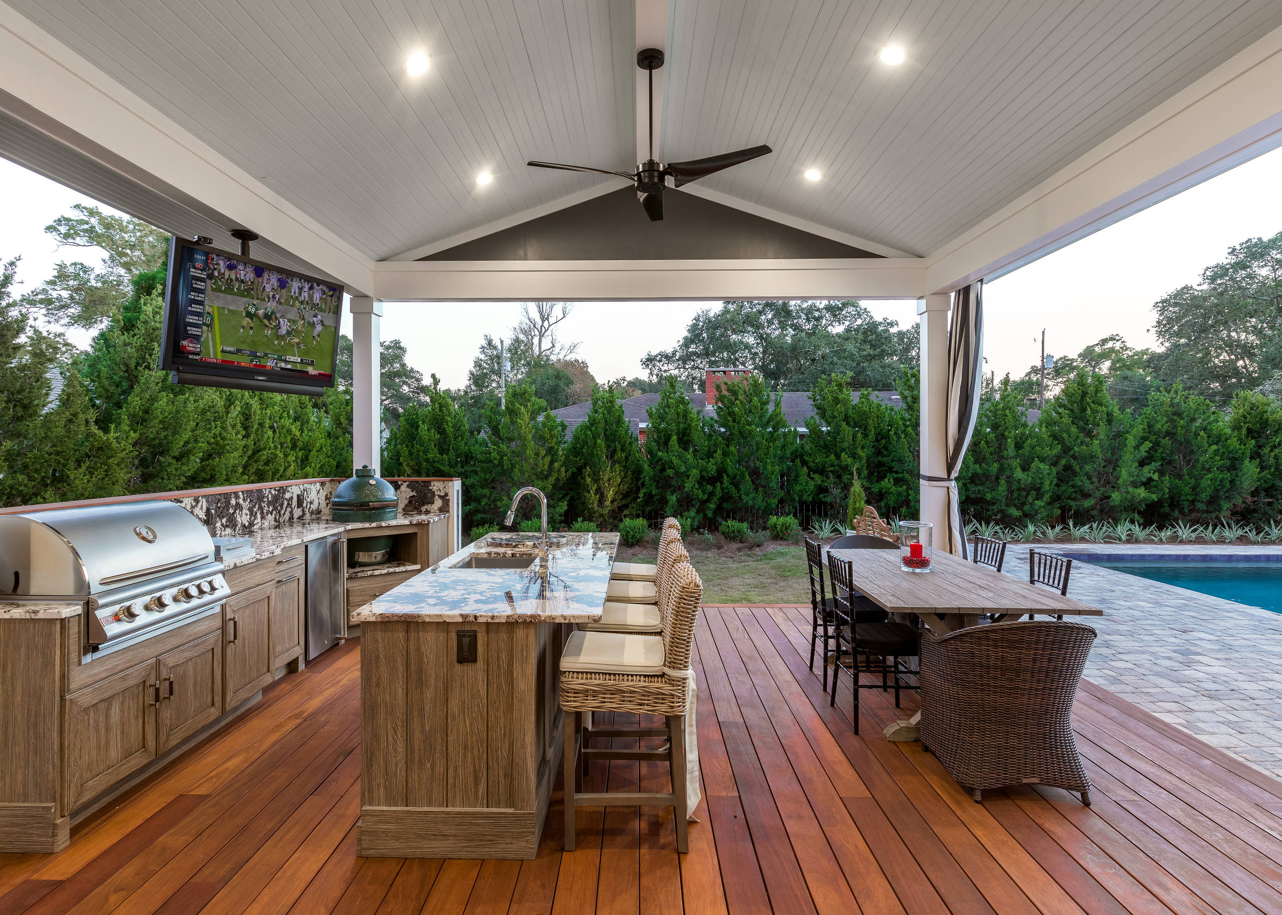 © Greg Riegler
Inspiration for a large timeless backyard deck remodel in Other with a roof extension